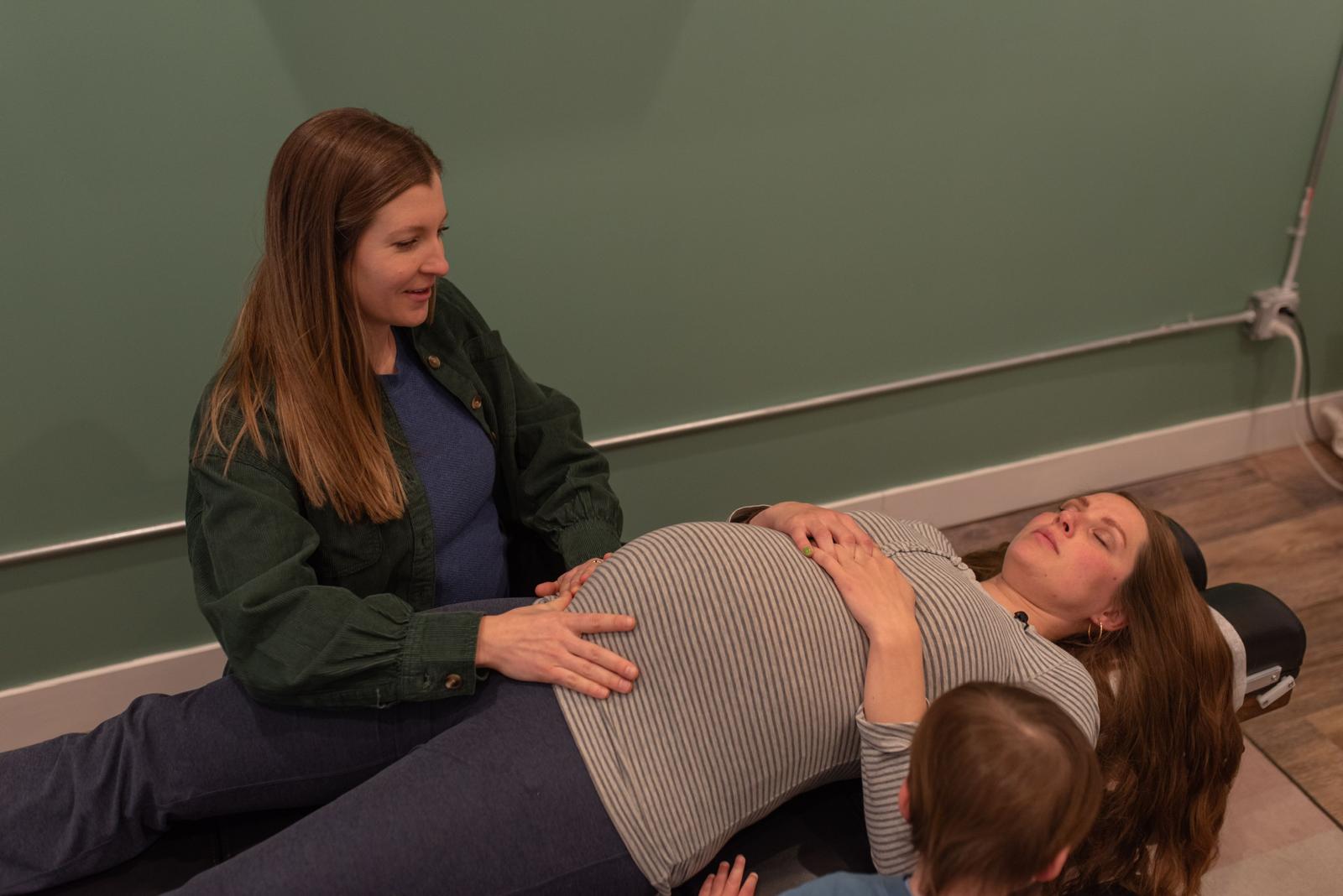 Prenatal chiropractic adjustment for expecting mom at Calmbody Chiropractic Club